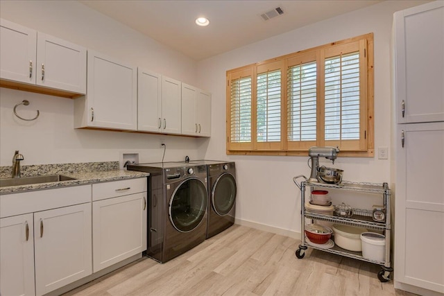 laundry area featuring cabinet space, washer and dryer, light wood-style flooring, baseboards, and recessed lighting