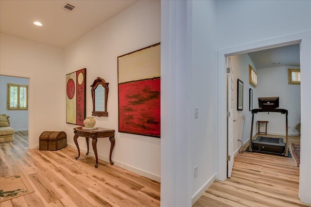hall with wood finished floors, baseboards, and recessed lighting