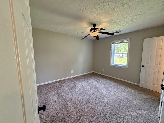 unfurnished bedroom with carpet floors, baseboards, visible vents, a ceiling fan, and a textured ceiling