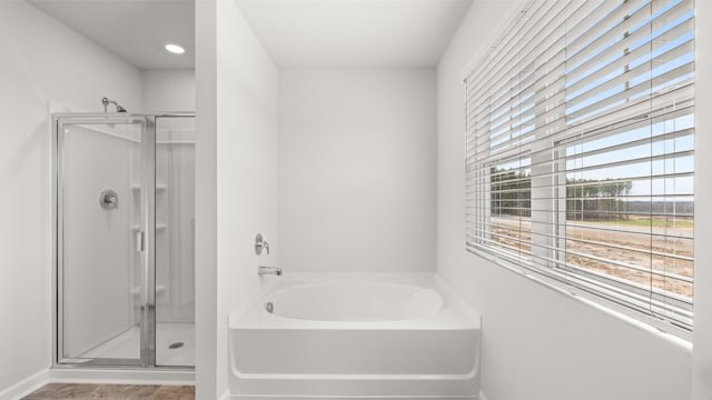 bathroom featuring independent shower and bath