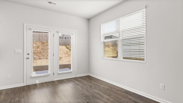 unfurnished room with dark hardwood / wood-style floors