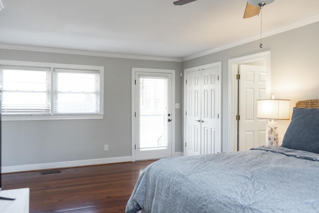 bedroom with dark hardwood / wood-style flooring, crown molding, and ceiling fan