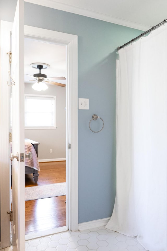 bathroom featuring hardwood / wood-style flooring, ornamental molding, and ceiling fan