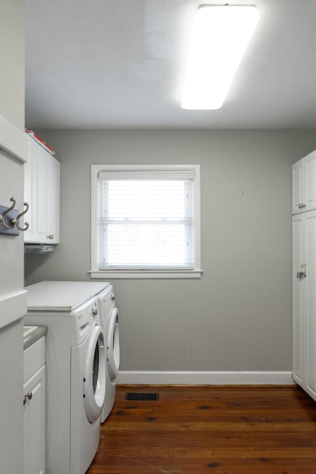 washroom featuring cabinets, dark hardwood / wood-style flooring, and independent washer and dryer