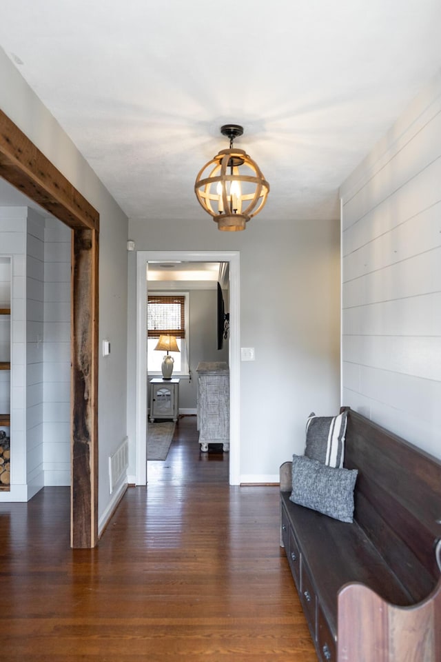 sitting room with a chandelier and dark hardwood / wood-style flooring