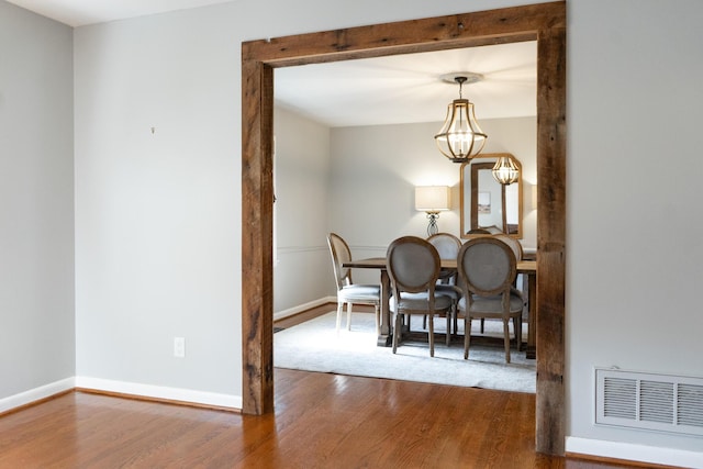 dining room featuring wood-type flooring and a notable chandelier