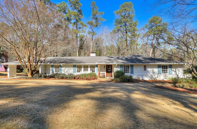 ranch-style home with a front lawn