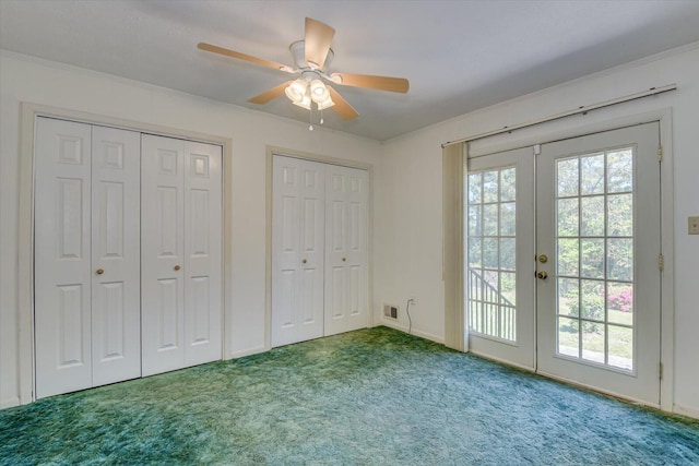 unfurnished bedroom with ceiling fan, access to exterior, carpet flooring, two closets, and french doors