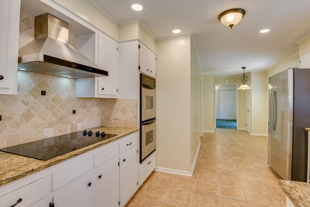 kitchen with stainless steel appliances, hanging light fixtures, white cabinets, and wall chimney exhaust hood