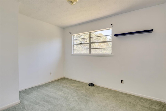 carpeted spare room featuring a textured ceiling