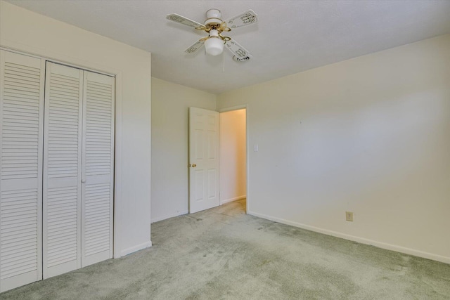 unfurnished bedroom with light carpet, ceiling fan, and a closet