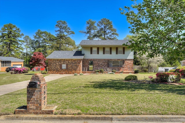 view of front of property featuring a garage and a front yard