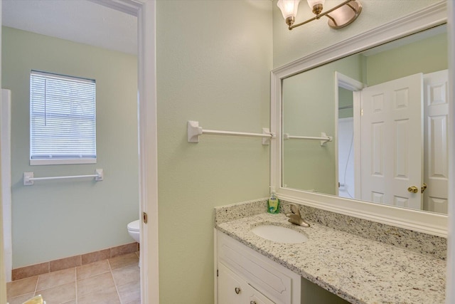 bathroom featuring vanity, tile patterned floors, and toilet