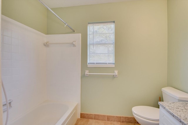 full bathroom featuring washtub / shower combination, tile patterned floors, toilet, and vanity