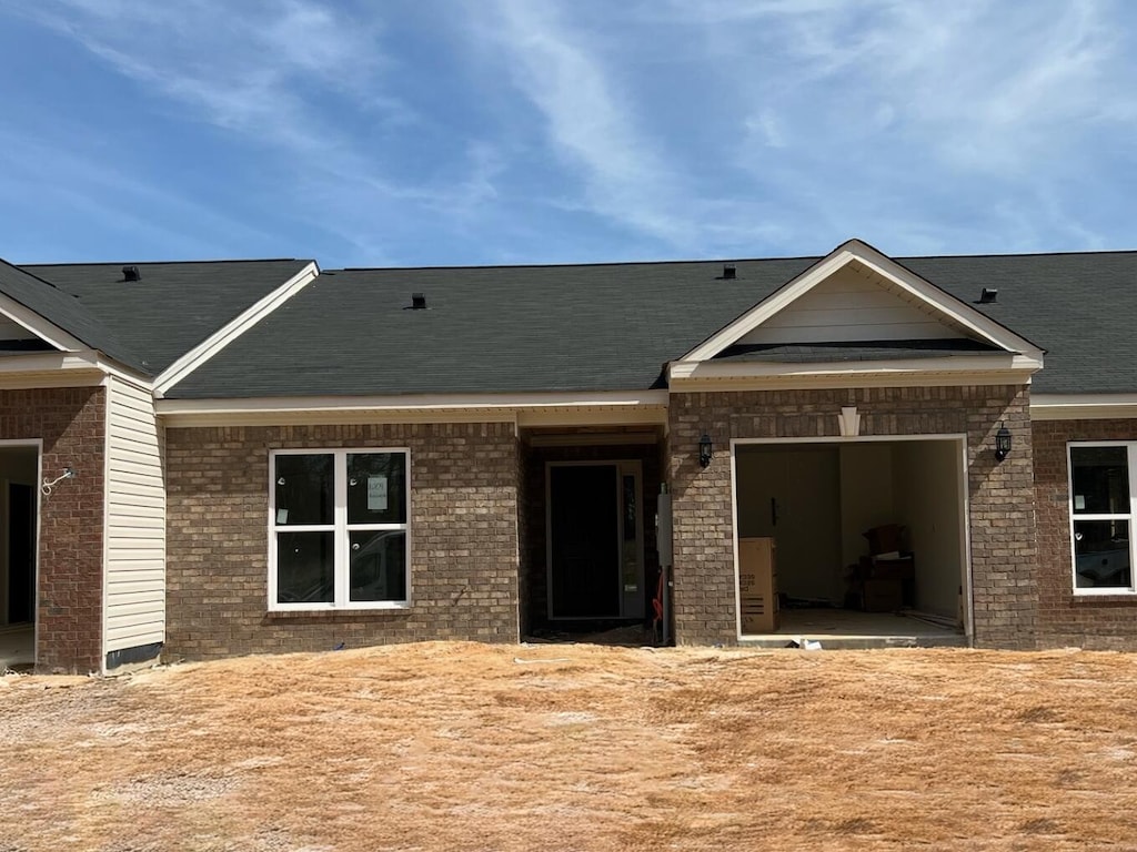 view of front of home with brick siding and an attached garage