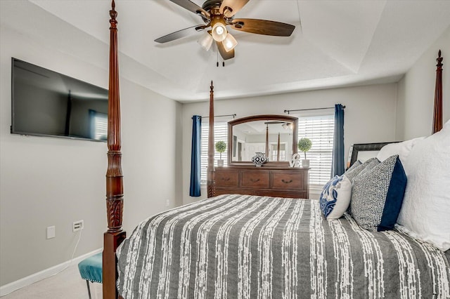 carpeted bedroom featuring baseboards and a ceiling fan