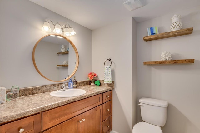 half bathroom with visible vents, toilet, and vanity