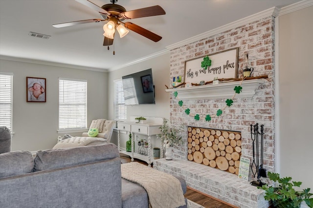 living room with visible vents, crown molding, a ceiling fan, and wood finished floors