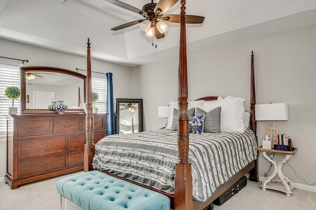 bedroom with light colored carpet, baseboards, and a ceiling fan