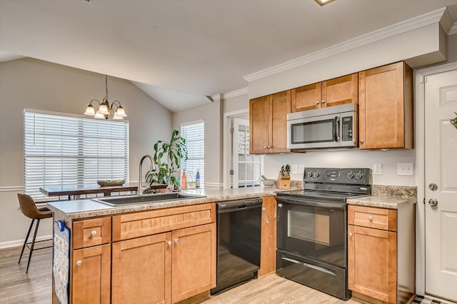 kitchen featuring light wood-type flooring, a peninsula, a notable chandelier, black appliances, and a sink