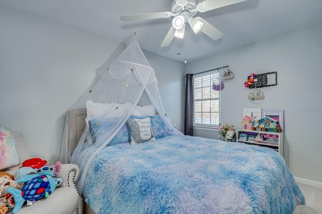 bedroom with baseboards, a ceiling fan, and carpet