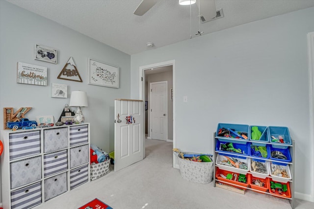 game room with visible vents, ceiling fan, a textured ceiling, and carpet