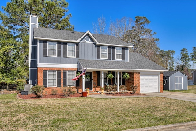 view of front of house featuring a front lawn, brick siding, an attached garage, and driveway