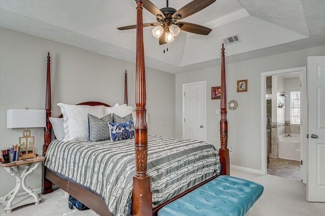 bedroom with visible vents, a raised ceiling, a textured ceiling, and carpet floors