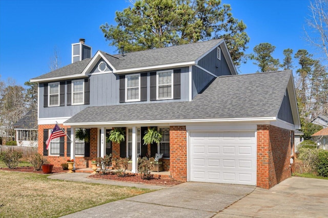 traditional-style home featuring roof with shingles, an attached garage, a chimney, concrete driveway, and brick siding