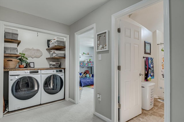 laundry area featuring laundry area, light colored carpet, baseboards, and washing machine and clothes dryer