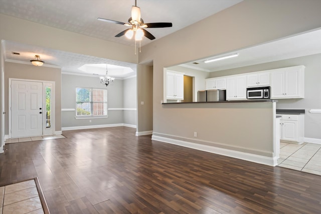 2042 Silver Run Fls, Grovetown, GA 30813 - unfurnished living room with a chandelier, wood finished floors, a ceiling fan, and ornamental molding