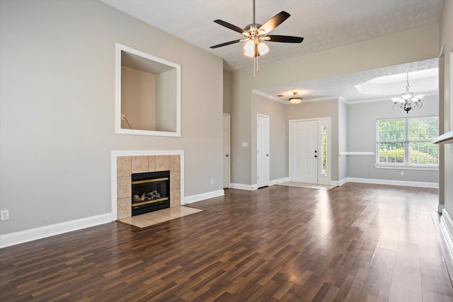 2042 Silver Run Fls, Grovetown, GA 30813 - unfurnished living room featuring a tiled fireplace, dark wood-style floors, a chandelier, and a ceiling fan