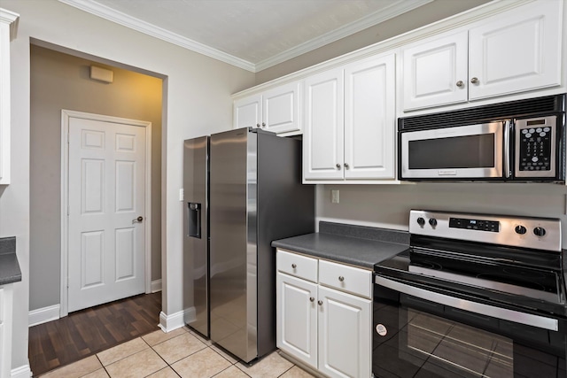2042 Silver Run Fls, Grovetown, GA 30813 - kitchen with stainless steel appliances, dark countertops, white cabinetry, crown molding, and light tile patterned floors