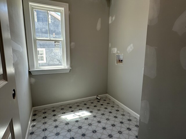 laundry room with baseboards, laundry area, and washer hookup