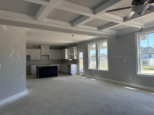 unfurnished living room featuring crown molding, beam ceiling, baseboards, ceiling fan, and coffered ceiling