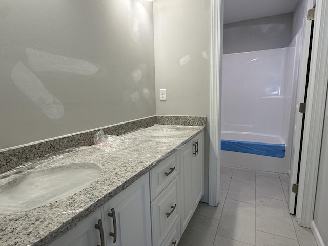full bath with tile patterned flooring, double vanity, and a sink