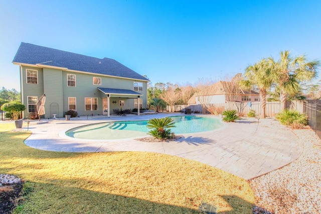 view of swimming pool featuring a yard and a patio