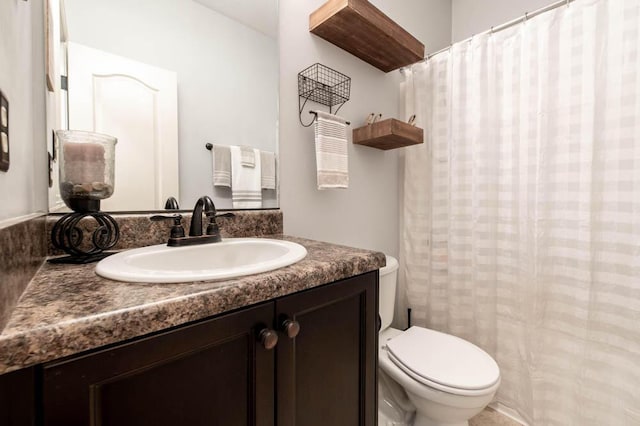 bathroom featuring toilet and vanity