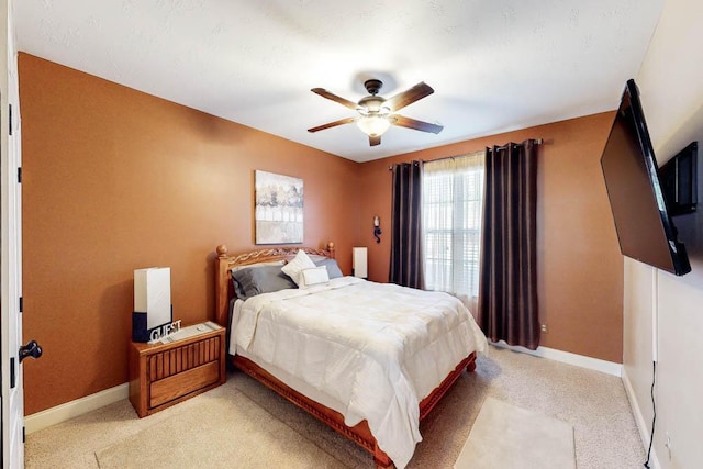 bedroom featuring ceiling fan and light carpet