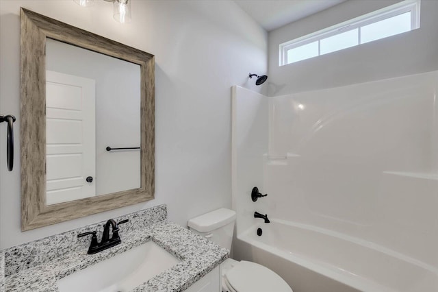 full bathroom with toilet, vanity, and washtub / shower combination