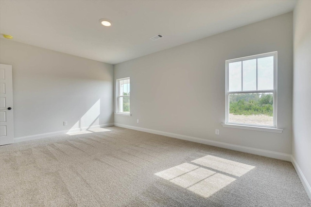 unfurnished room with light colored carpet