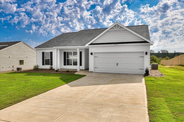 view of front of house with cooling unit, a garage, and a front yard