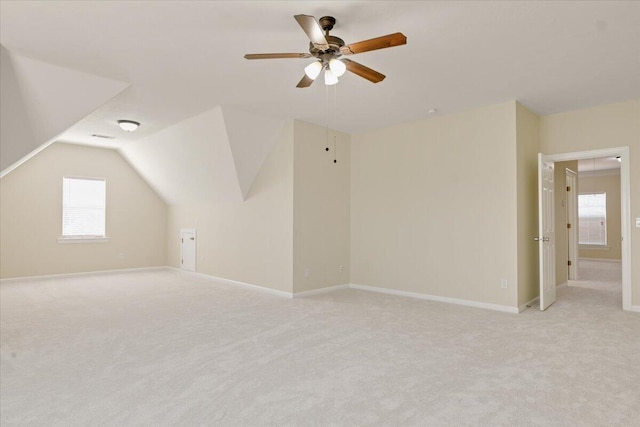 bonus room featuring ceiling fan, vaulted ceiling, and light carpet