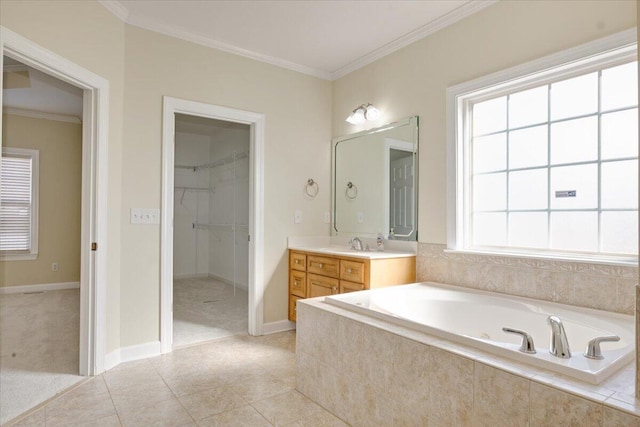 bathroom with ornamental molding, tiled bath, vanity, and tile patterned floors