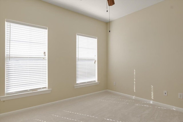 unfurnished room with ceiling fan and light carpet