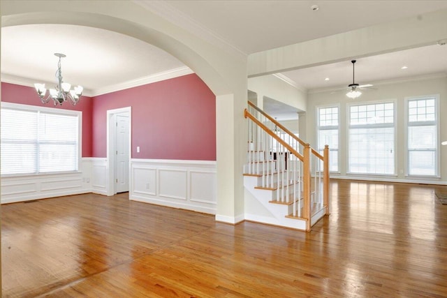 interior space featuring crown molding, wood-type flooring, and a healthy amount of sunlight