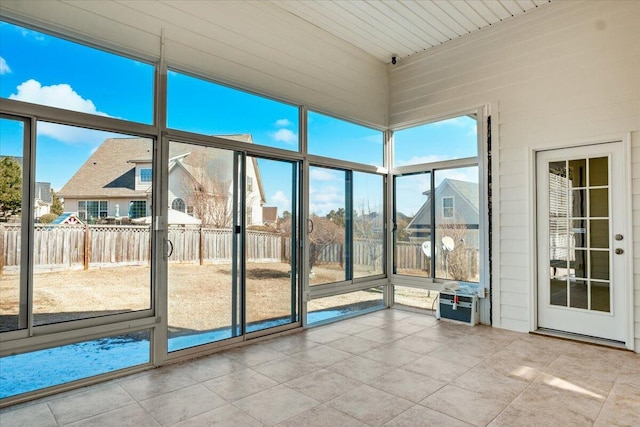 unfurnished sunroom featuring a wealth of natural light