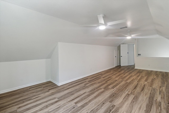 bonus room featuring wood finished floors, ceiling fan, visible vents, and vaulted ceiling