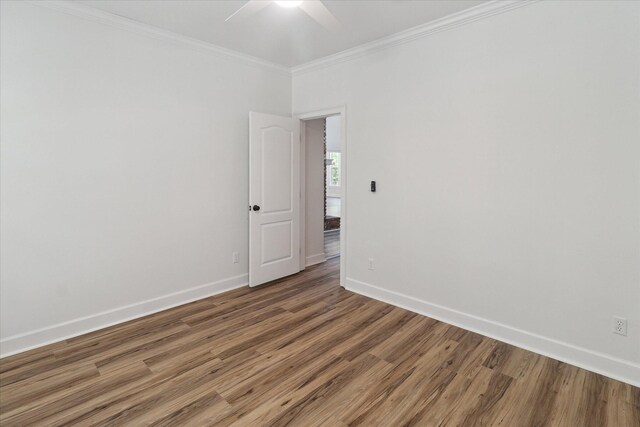 unfurnished room featuring baseboards, light wood-type flooring, a ceiling fan, and crown molding