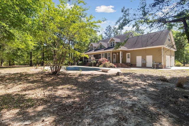 back of house featuring an outdoor pool